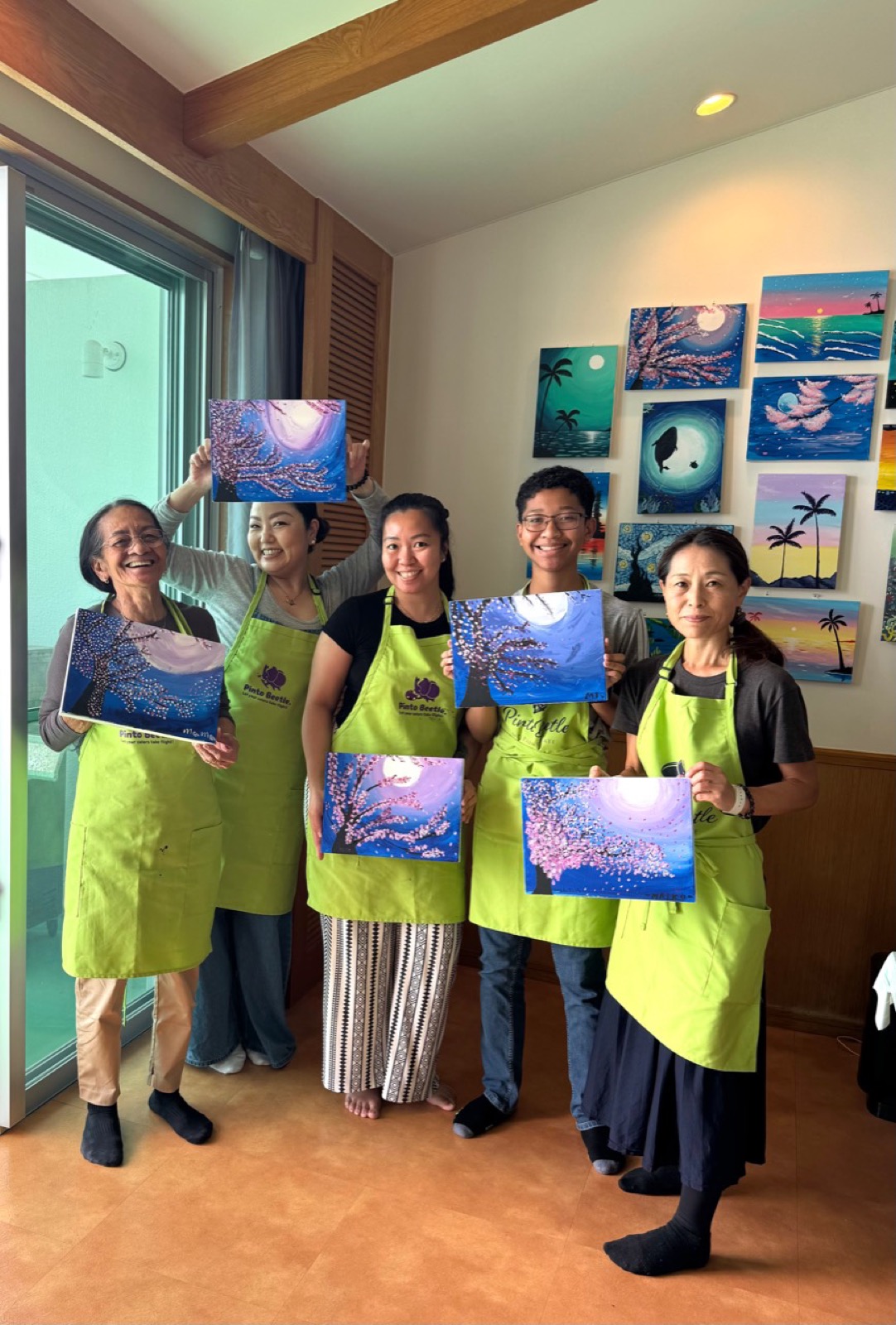 Pinto Beetle guests smiling with their finished cherry blossom paintings