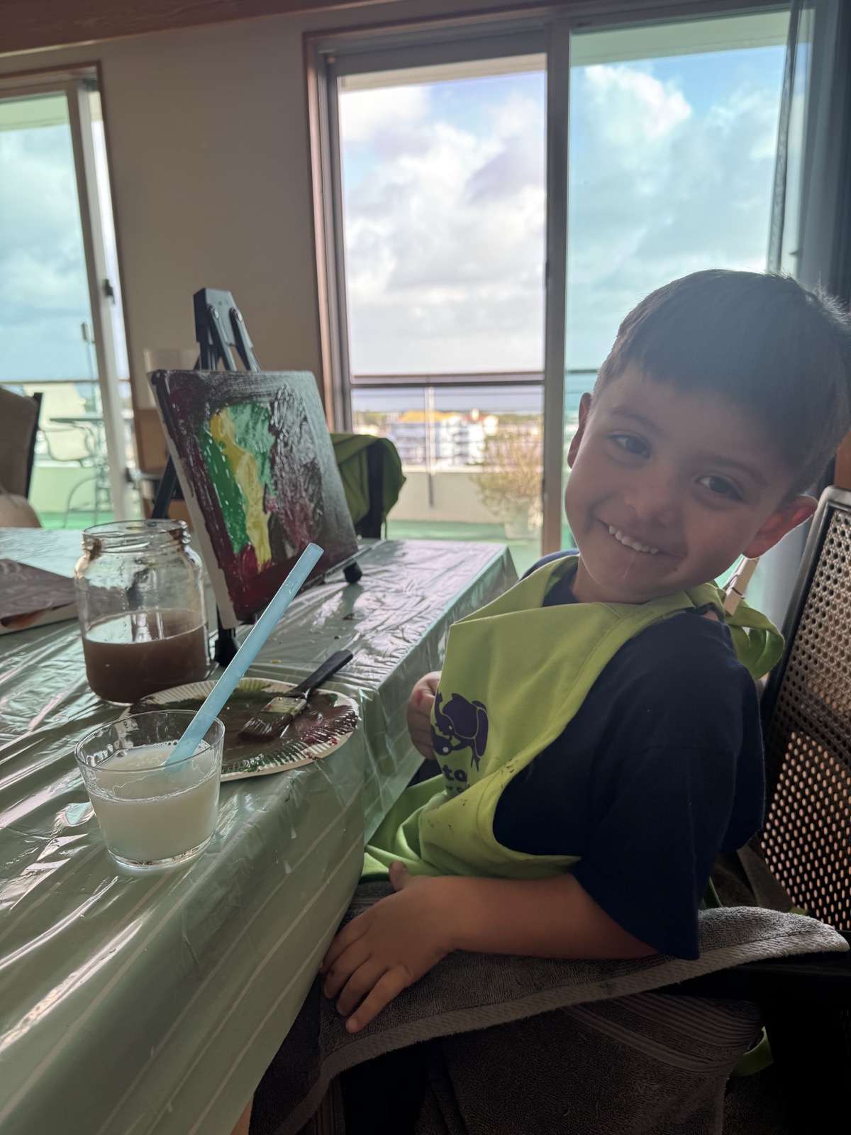 Young Pinto Beetle guest smiling beside his painting