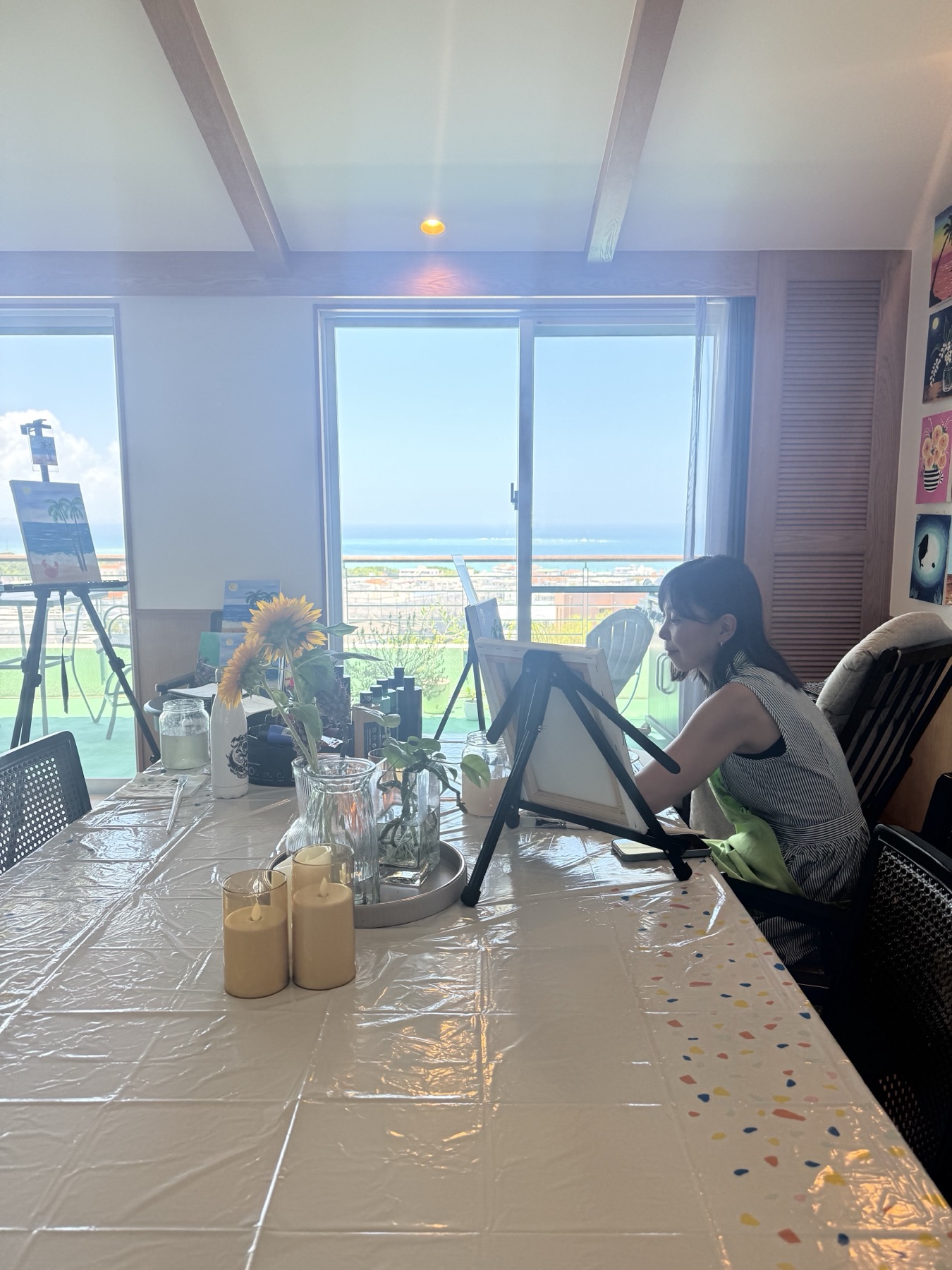 Pinto Beetle guest painting in the ocean-view studio during a Palm tree and Little Crab class