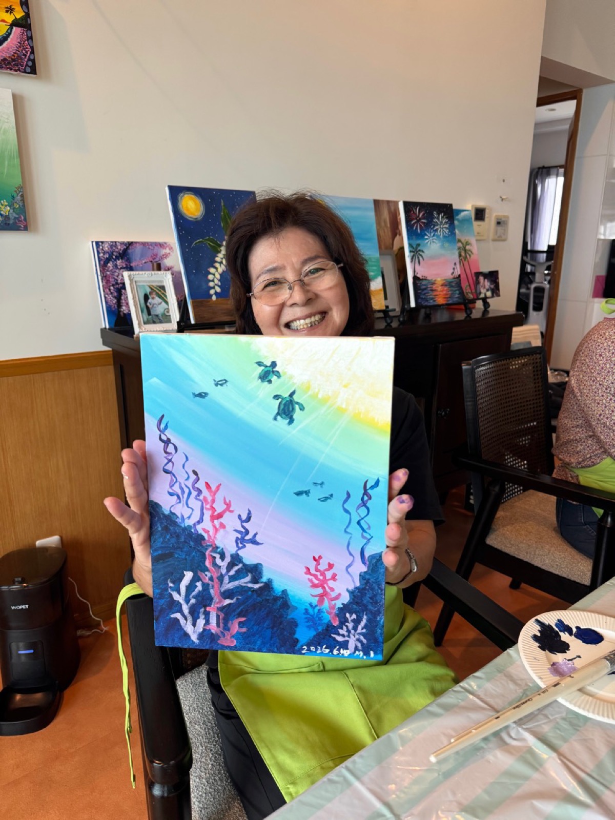 Pinto Beetle guest proudly holding her finished sea turtle painting
