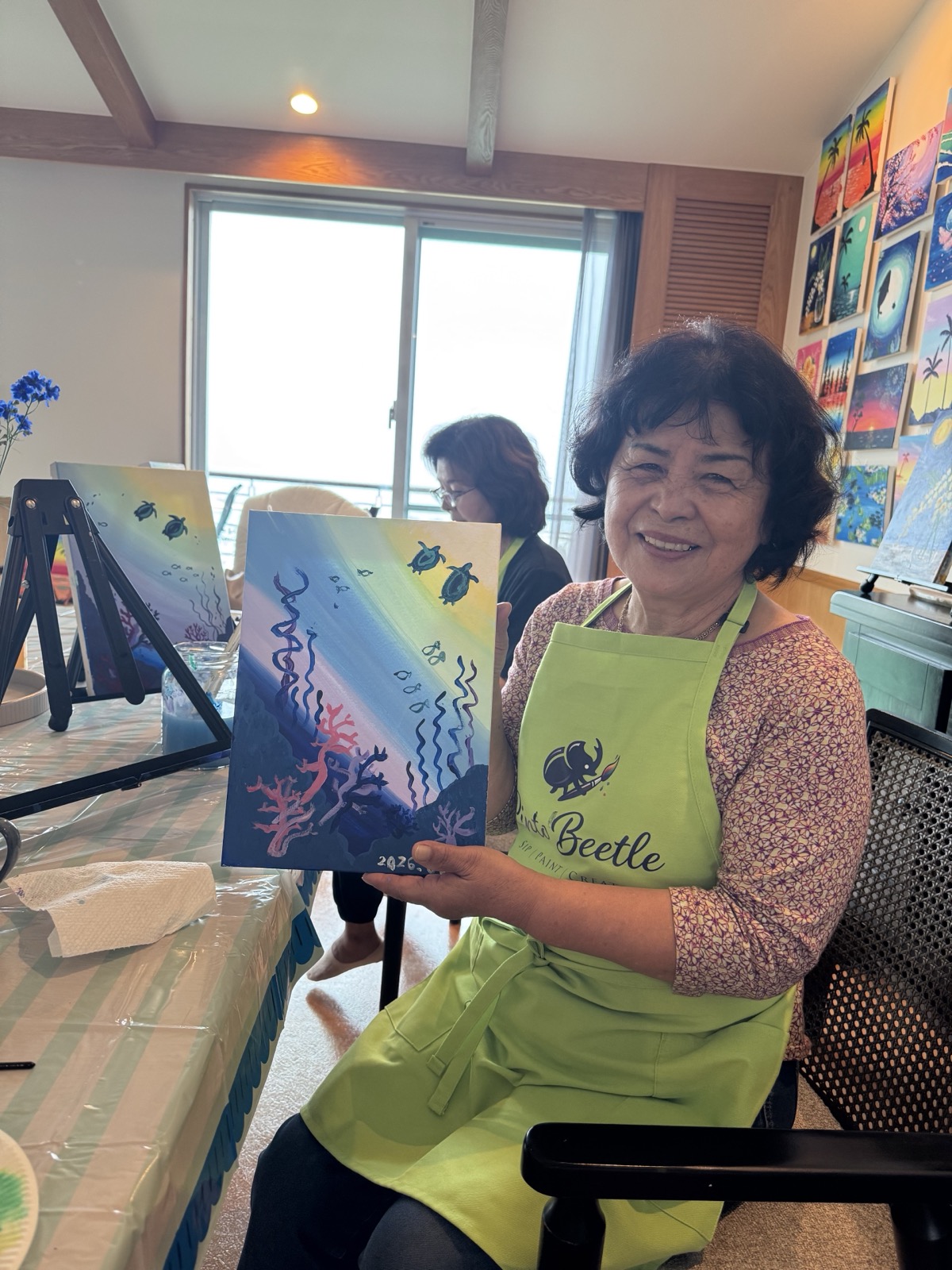 Pinto Beetle guest smiling with her finished sea turtle painting